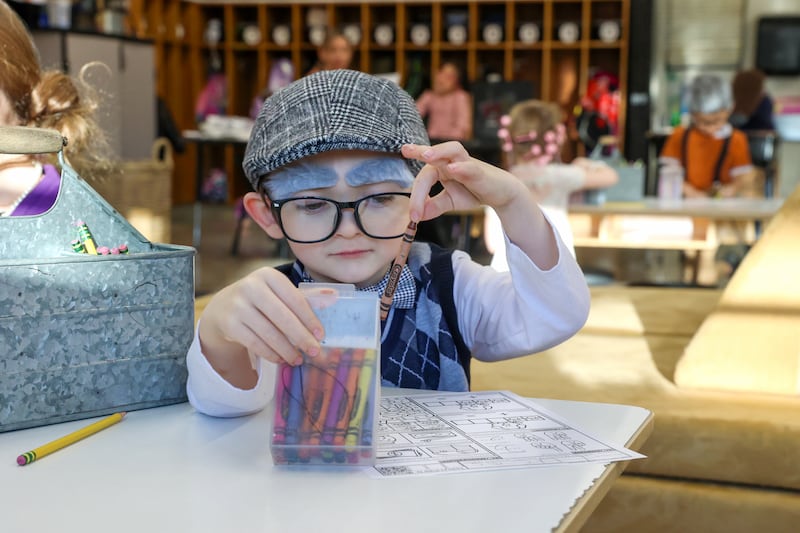 Shabbona Elementary School kindergartener Lucas Akai chooses a crayon while dressed up as a 100 year old for the 100th day of school on Monday, Feb. 9, 2026.