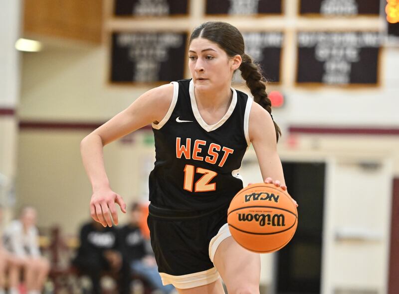 Lincoln-Way West's Caroline Smith (12) drives to the basket during a conference game against Lockport on Tuesday, Feb. 04, 2025, at Lockport.