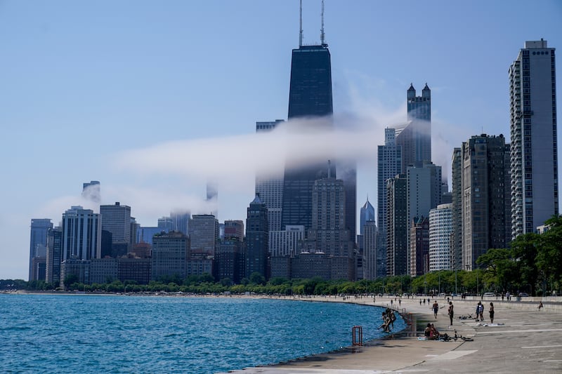 The Chicago city skyline is covered by the fog lifted off Lake Michigan on Aug. 5, 2022, in Chicago. Democrats have chosen Chicago to host their 2024 national convention. (AP Photo/Kiichiro Sato, File)