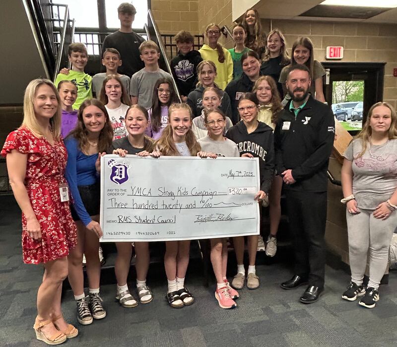 Reagan Middle School student council presenting $320 check donation to Dixon Family YMCA