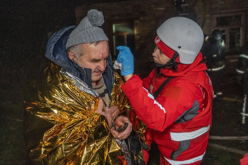 A paramedic gives first aid to a resident who was injured in a Russian airstrike in Kharkiv, Ukraine, late Sunday, Nov. 23, 2025. (AP Photo/Andrii Marienko)