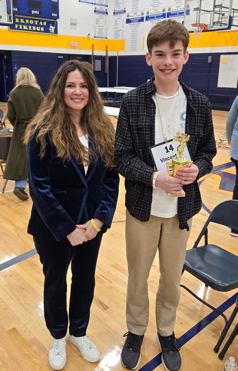Eighth grader Vincent Brendel (left), from Saint Mary Catholic School in Woodstock, stands with McHenry County Regional Office of Education Superintendent Diana Hartmann after winning the 2026 McHenry County Regional Spelling Bee.