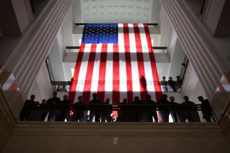 A large American flag is draped over windows of the Illinois State Library in Springfield during the Illinois Peace Officers Memorial Ceremony on Thursday, May 1, 2025. (Capitol News Illinois photo by Jade Aubrey)