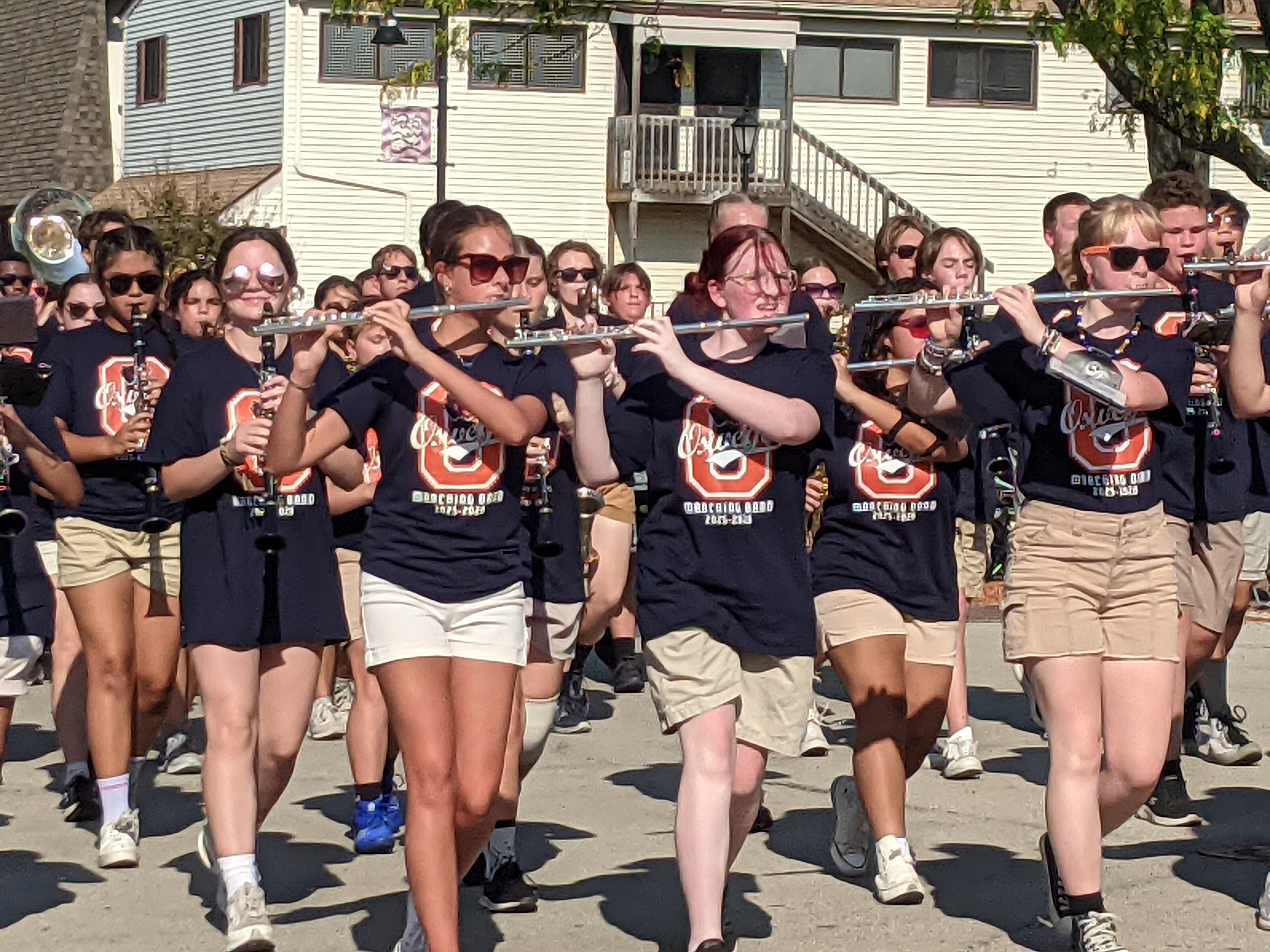 The Oswego High School Marching Band marches through downtown Oswego as part of the high school's homecoming parade on Sept. 28, 2025.