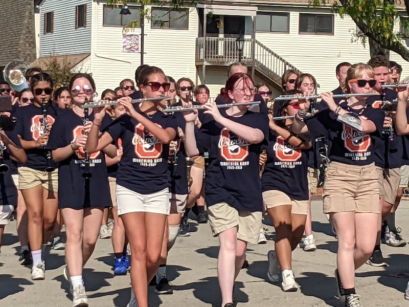 The Oswego High School Marching Band marches through downtown Oswego as part of the high school's homecoming parade on Sept. 28, 2025.