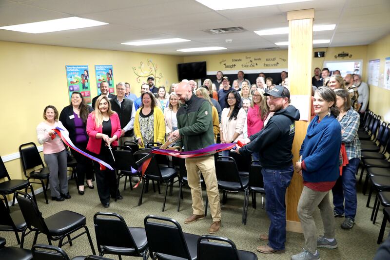 Kendall County Food Pantry Executive Director Alex Hurd cuts the ribbon of the newly refurbished facility during an open house and ribbon-cutting ceremony on Wednesday, April 16, 2025 in Yorkville.