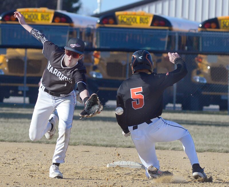Woodland SS Nolan Price tries to catch a wide throw as Roanoke Benson’ Javin Feucht gets into 2nd safely on a stolen base in the 4th inning Tuesday at Woodland.