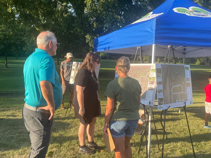 Attendees approach project leaders with feedback Wednesday, Aug. 13, 2025, during an open house at Prairie Park in DeKalb.