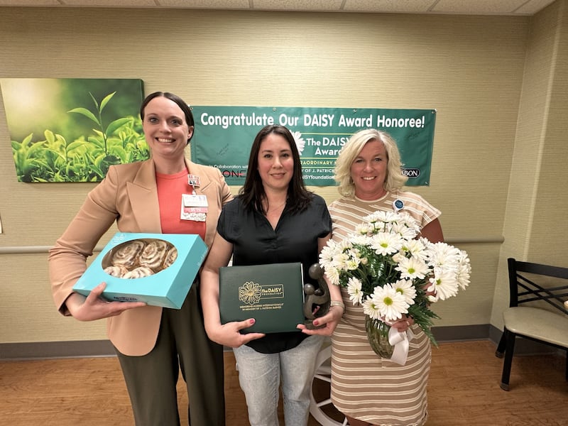 Biatris Escatel, RN at OSF Saint Clare Medical Center, was honored with the 2025 DAISY Award for her compassionate care and dedication to patients. From left: Lori Anderson, DNP, Inpatient Services manager; 2025 DAISY Award Winner, Biatris Escatel, RN; Heather Bomstad, chief nursing officer.