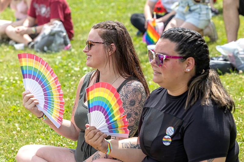Calandra Vasquez (left) and Linsey Hepker, both of Sterling, watch a performance Saturday, June 15, 2024 at Dixon Pride Fest.