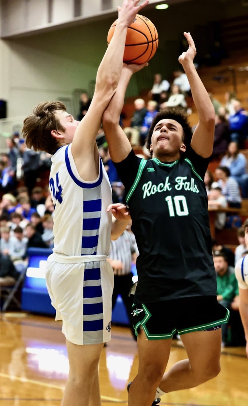 Princeton's Ryan Jagers gets a piece of the rock on this second-half shot by Rock Falls' Z'viyon Martin in Tuesday's game at Prouty Gym. The Rockets won 61-58.