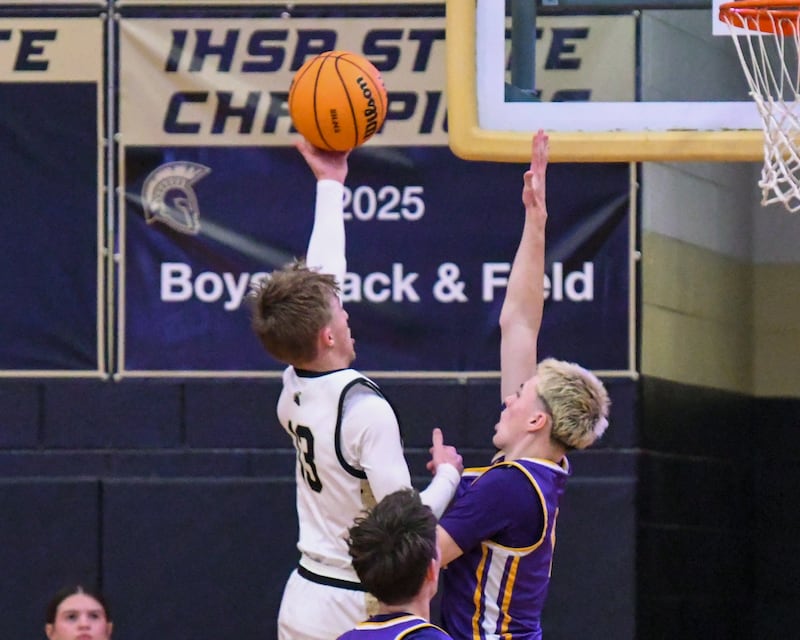 Sycamore's Xander Lewis, left, makes a basket while being defended by Mendota's Alex Beetz (3) during the game on Wednesday Dec. 17, 2025, held at Sycamore High School.