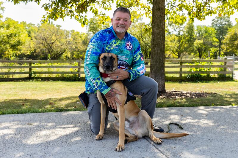 Marine veteran Jeremy Eaton enjoys spending time with his dog Riot, who is being trained as a therapy dog by K9s for Veterans, at the Hammel Woods Dog Park in Shorewood on Oct. 2, 2025.