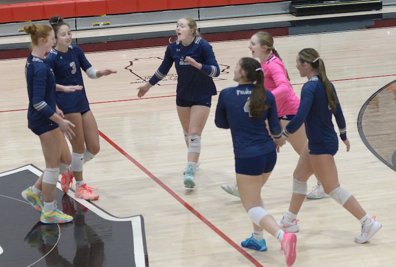 Fieldcrest celebrates an opening-set point against Woodland during the teams' Class 1A regional quarterfinal Tuesday, Oct. 28, 2025, at Woodland School in rural Streator.