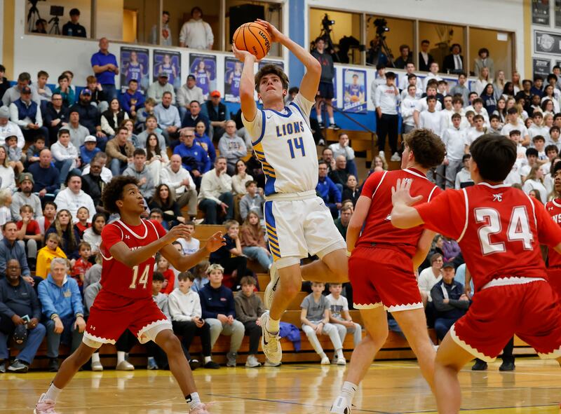 Lyons Township's Grant Smith (14) puts up a shot during a varsity basketball game between Hinsdale Central and Lyons Township high schools on Friday, Dec. 12, 2025 in La Grange.