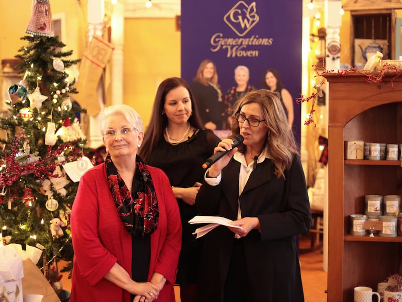 The Generations Woven trio, left to right, Judy Randall, Tasha Garcia and Nerina Human, with microphone, give a talk.