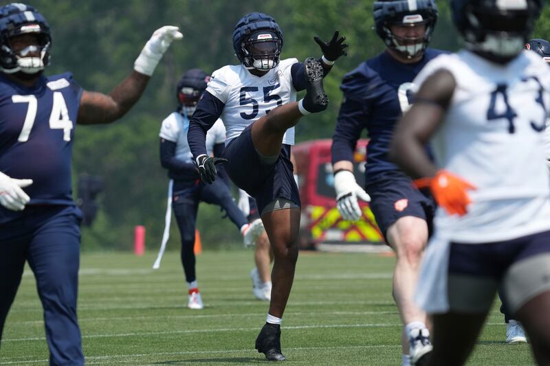 Chicago Bears defensive end Dayo Odeyingbo (55) warms up with teammates during NFL football practice at Halas Hall in Lake Forest, Ill., Thursday, June 5, 2025. (AP Photo/Nam Y. Huh)