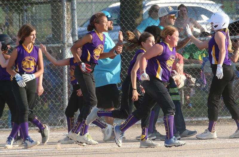 Members of the Warriors softball team smile after winning the Ottawa Girls Fastpitch Association 11U City Championship on Wednesday July 2, 2025 at Peck Park in Ottawa.