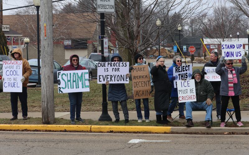 Protesters hold signs during a "ICE Out For Good" protest on Saturday, Jan. 10, 2026 at Rotary Park in Princeton. The Bureau County Democrats organized the event. About two-dozen protesters gathered to protest the ICE officer who shot and killed Renee Nicole Good in Minneapolis on Jan. 7.