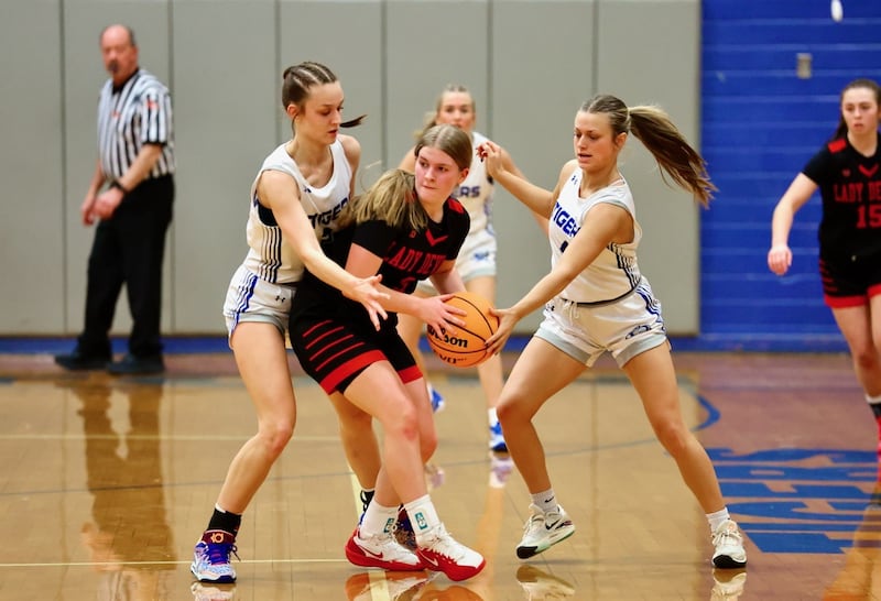 Hall's Leah Pelka feels the pinch between Princeton's Keighley Davis (left) and Madie Gibson Tuesday night at Prouty Gym. The Tigresses won 41-39.