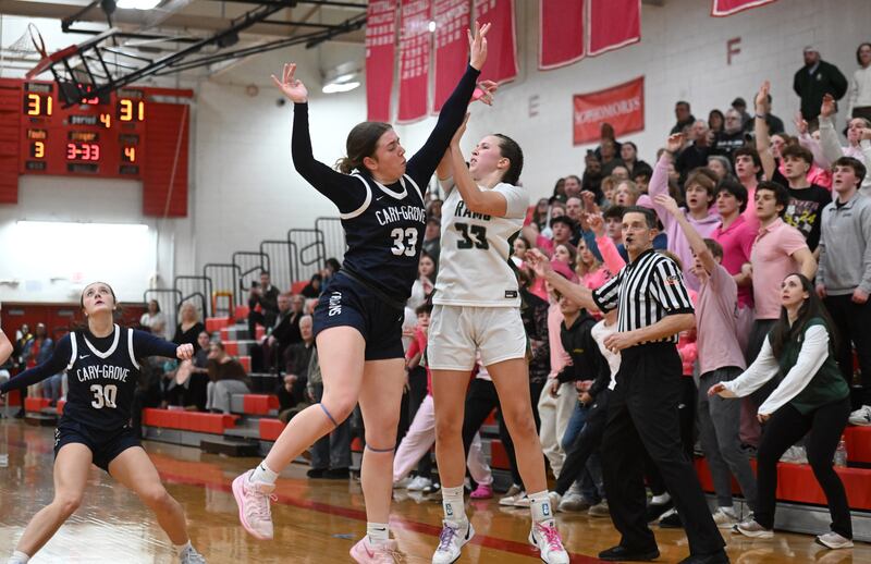 Cary-Grove's Ellie Mjaanes, left, fouls Grayslake Central’s Madison Hoffmann on an attempted three-pointer with one second left in overtime during the Class 3A North Chicago sectional final on Thursday, Feb. 27, 2025 in North Chicago. Hoffmann hit two of the three free throws as the Rams won the game 33-31.
