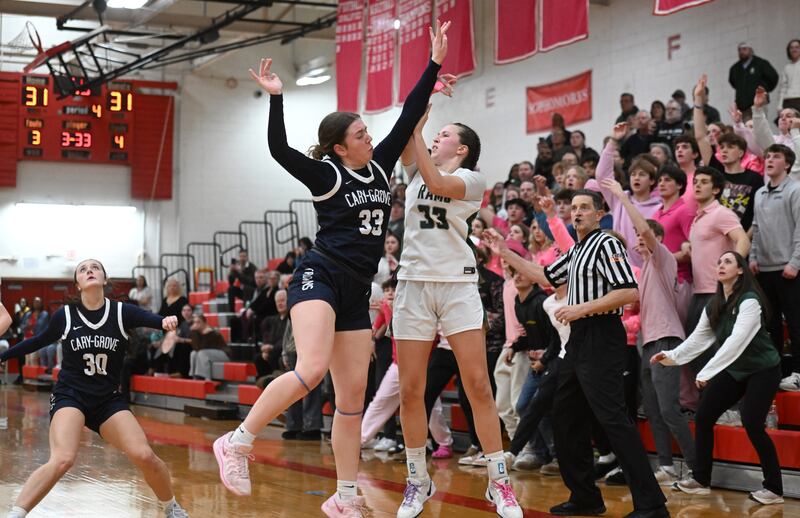 Cary-Grove's Ellie Mjaanes, left, fouls Grayslake Central’s Madison Hoffmann on an attempted three-pointer with one second left in overtime during the Class 3A North Chicago sectional final on Thursday, Feb. 27, 2025 in North Chicago. Hoffmann hit two of the three free throws as the Rams won the game 33-31.