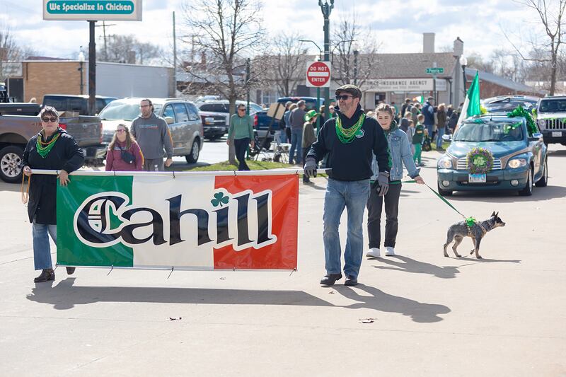 Lisa and Luke Dixon hoist the Cahill clan flag through the Rock River Valley Shamrock Club’s St. Patrick’s parade in Dixon Saturday, March 16, 2024. Crowds lined the streets to enjoy the parade and the weather.