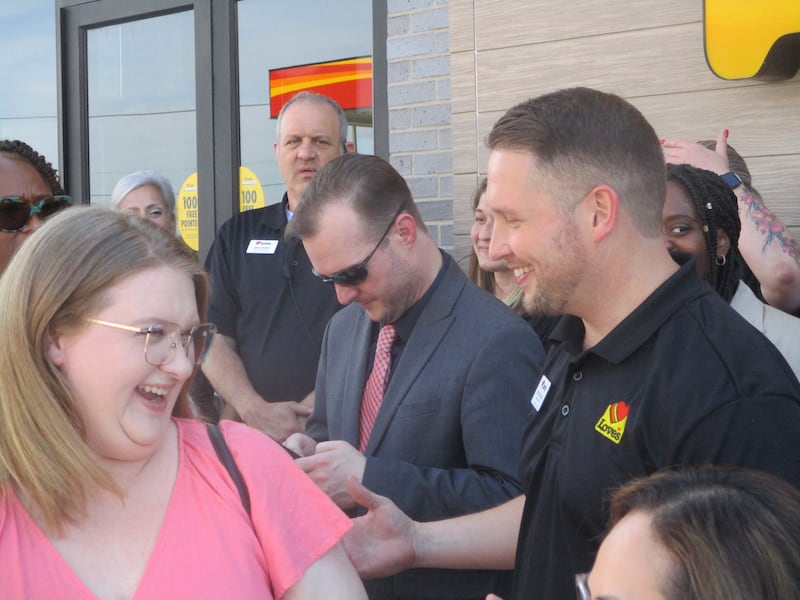 Cade McDougal (right), general manager at the Love's Travel Stop in Joliet, mingles with visitors lining up for a ribbon-cutting photos at the fuel center on Wednesday. June 3, 2026
