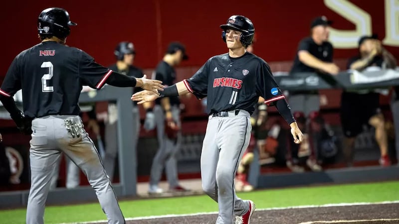 NIU baseball players Wyatt Wawro (11) and Charlie Parcell celebrate during the Huskies' 12-10 win over Coastal Carolina on May 29, 2026, in Tallahassee, Florida. It was the first NCAA Tournament win in program history.