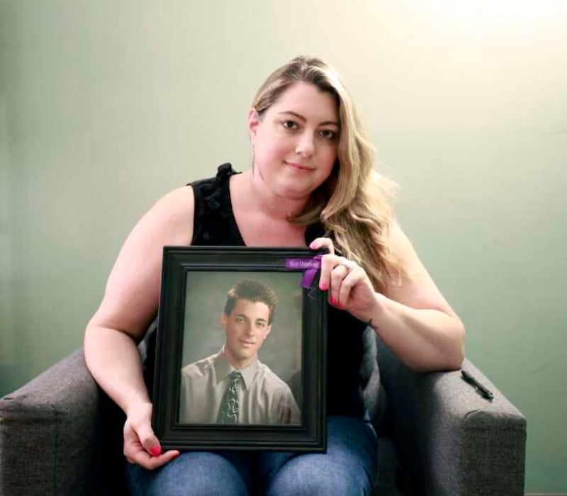 Chelsea Laliberte Barnes, co-founder of Live4Lali, chief operating officer of Wolf Pack and co-chair of the Illinois Harm Reduction and Recovery Coalition, holds a photo of her brother Alex Laliberte, who died of an accidental drug overdose.