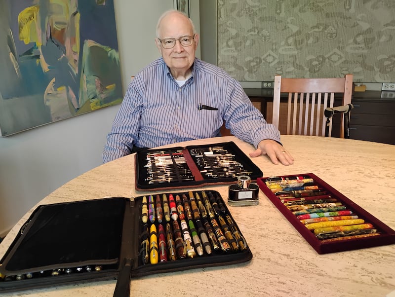 Paul Conterato of Geneva with some examples of his 1,500 fountain pen collection. In front are the Mont Blancs; to the left are assorted Italian-made pens; to the right are American reproductions of Esterbrook pens.