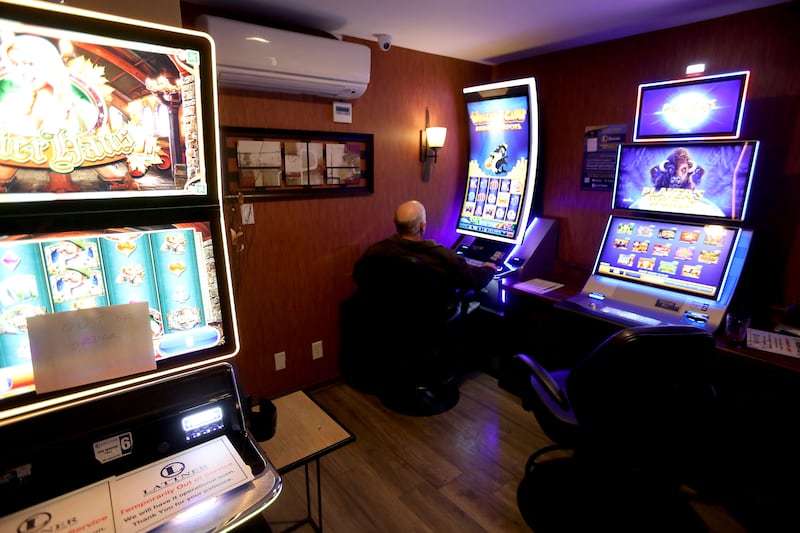 A woman plays a video gaming machine inside 3 Brothers Restaurant on Thursday, Jan. 22, 2026. Woodstock is considering additional regulations surrounding video gaming in the city.