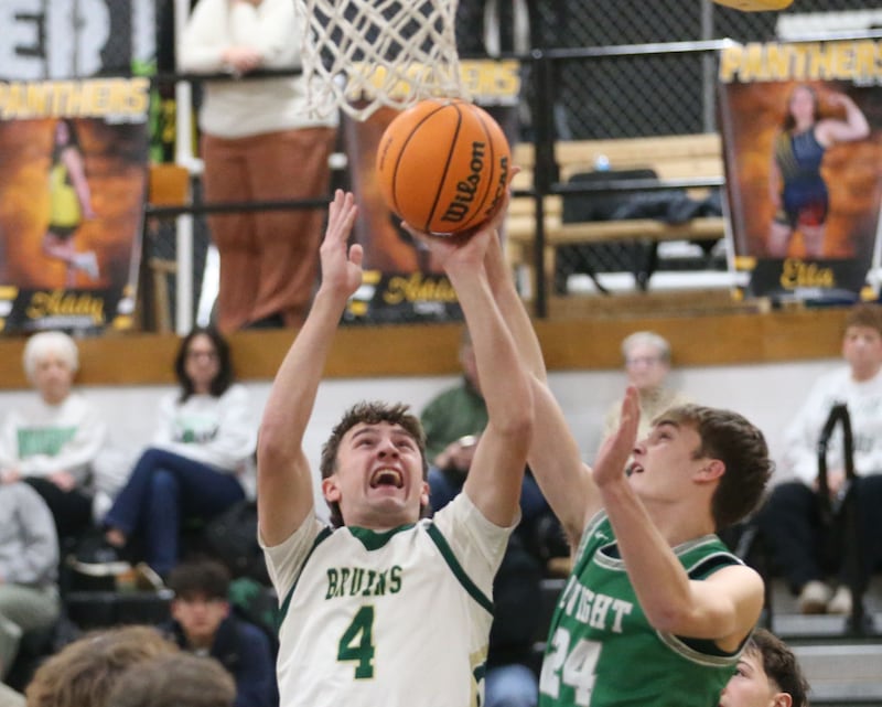St. Bede's Gino Ferrari eyes the hoop as Dwight's Trevor Jensen defends during the Tri-County Conference Tournament on Tuesday, Jan. 27, 2026 at Putnam County High School.