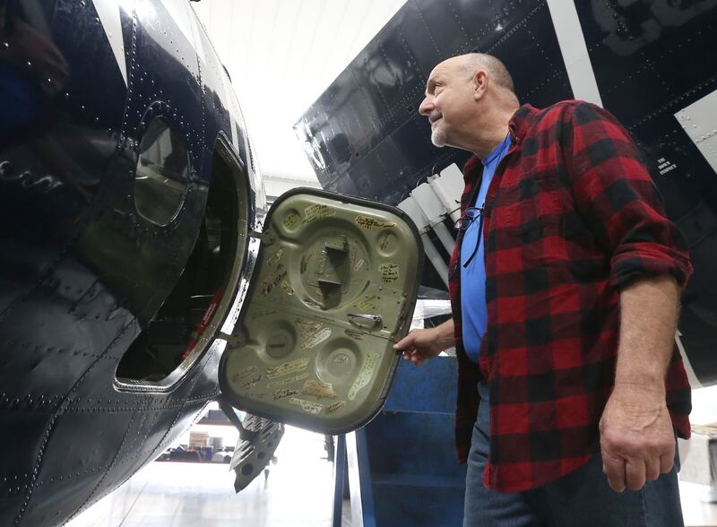 Brad Deckert opens the side door to his TBM Avenger aircraft on Tuesday, April 29, 2025 at the Illinois Valley Regional Airport in Peru. This year marks the 10th year of the annual TBM Reunion and Air Show that will take place May 16-17 at the airport.