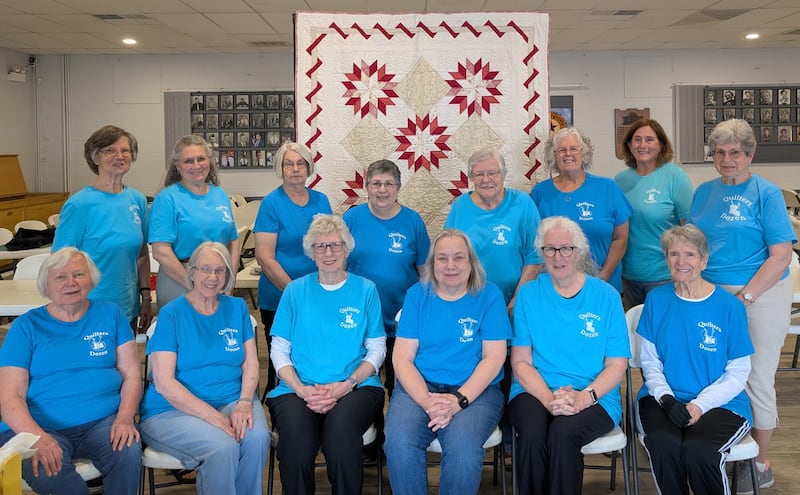 Quilters Dozen members pose with this year’s PrairieFest Quilt, "Suzie’s Stars," a traditional pattern piece hand-quilted by club members. The quilt will be raffled at this year’s PrairieFest Quilt Show at the Little White School Museum, 72 Polk St., Oswego.