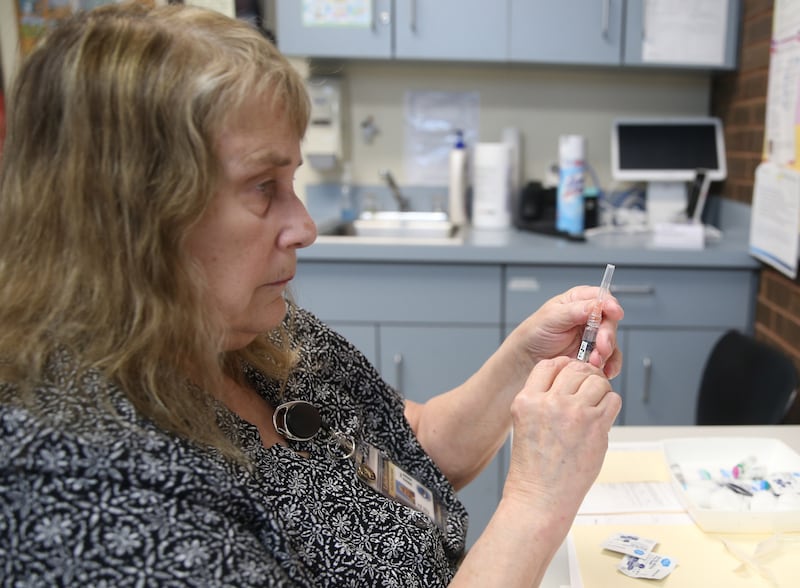 Lois Davis, public health nurse prepares a measles mumps rubella vaccine to a patient on Thursday, April 24, 2025 at the La Salle County Health Department in Ottawa.