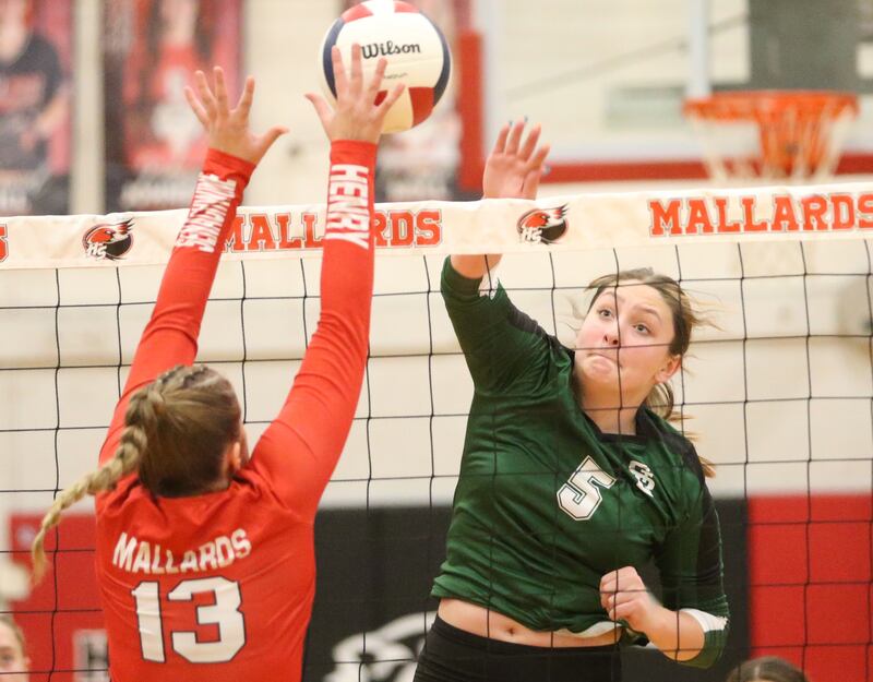 Henry-Senachwine's Grace Anderson blocks a spike from St. Bede's Jillian Pinter on Tuesday, Oct. 21, 2025 at Henry-Senachwine High School.
