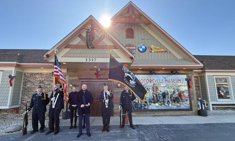 St. Charles Motorcycle Museum and Art Gallery owner Andy Coczwara (front) gives a speech before cutting the ribbon during the grant opening event on March 1, 2025, at 1317 E Main St. (Route 64) in St. Charles.