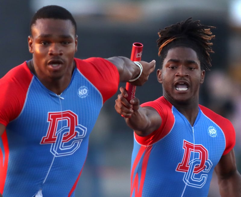 Dundee-Crown’s Eddie Bailey, right, hands off to Oreoluwa Sobodu in the 400-meter relay in Fox Valley Conference boys track and field meet action at Huntley High School in Huntley on Thursday, May 15, 2025. The Chargers won the event.