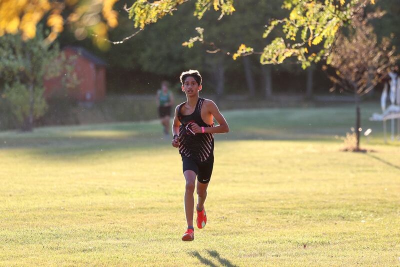 Bradley-Bourbonnais' Kyler Savini nears the finish line in first place in the boys 3-mile race during All-Area Cross Country meet on Wednesday, Oct. 8, 2025, at Kankakee Community College.