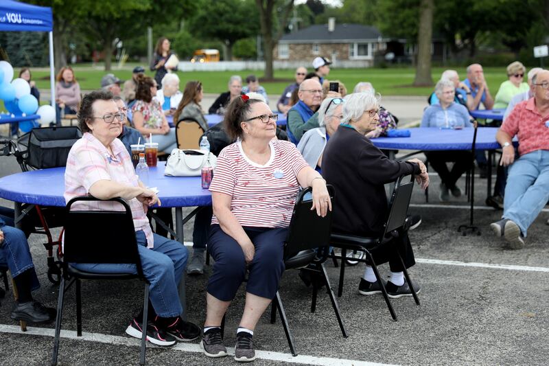 Community members gathered to speak out against cuts to the federal Older Americans Act at the Senior Services Associates community center in Yorkville.