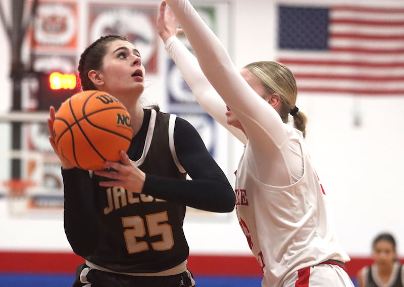 Jacobs’ Olivia Schuster works under the hoop  in varsity girls basketball on Friday, Dec. 12, 2025, at Dundee-Crown High School in Carpentersville.