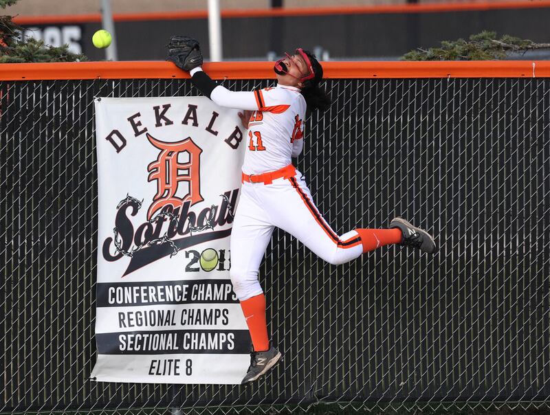 DeKalb's Sydney Myles can’t quiet make the catch on a Naperville Central home run Tuesday, April 16, 2025, during their game at DeKalb High School.