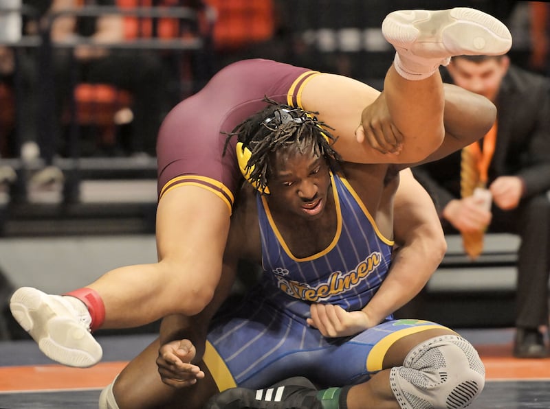 Charles Walker of Joliet Central wrestles Loyola’s Kai Calcutt in the Class 3A 215-pound final at the IHSA boys state wrestling championships at the State Farm Center in Champaign on Saturday, Feb. 22, 2025.