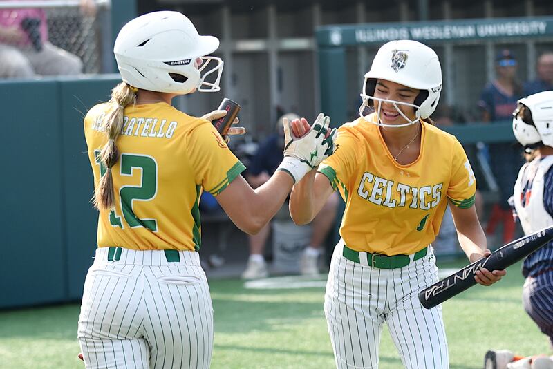Providence's Bella Cortes, right, is congratulated by teammate Mia Sanfratello after scoring a run during the Class 3A Illinois Wesleyan Supersectional against Pontiac Monday, June 9, 2025.
