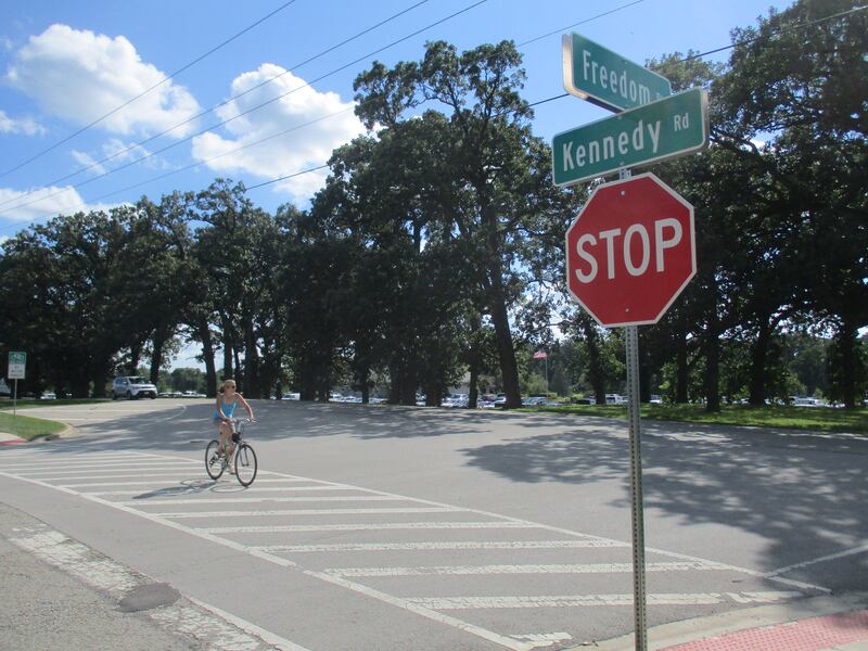 A bicyclist crosses Freedom Place at the intersection with Kennedy Road in Yorkville. (Mark Foster -- mfoster@shawmedia.com)