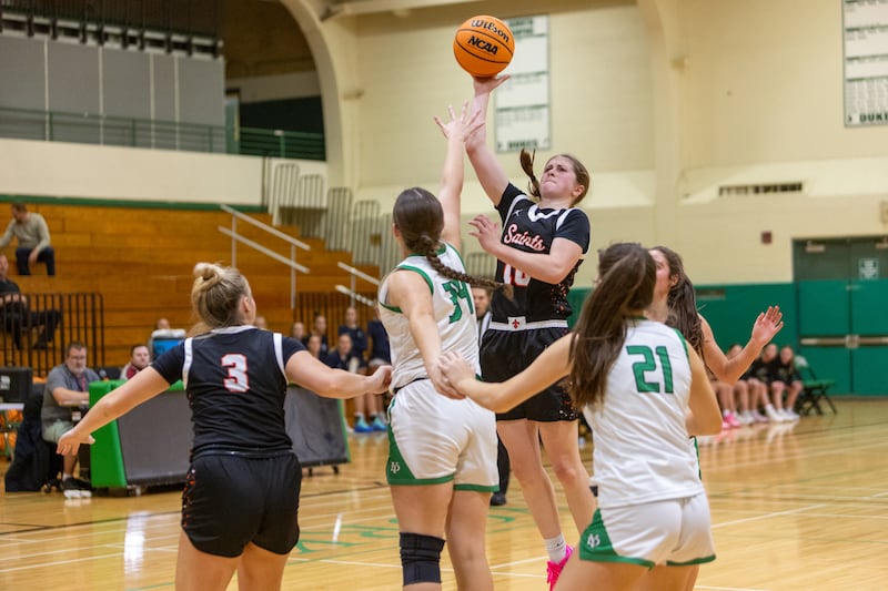 St. Charles East's Kathylyn Bainbridge shoots a jumper over York's Olivia Silkaitis at the York Girl's Thanksgiving Tournament on Tuesday, Nov. 18,2025 in Elmhurst.