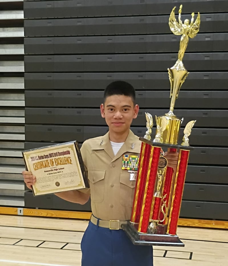 Romeoville High School Cadet Captain Neon Ibanez displays the second-place trophy earned by the unit's Marine Corps Junior ROTC program at the national drill championship.