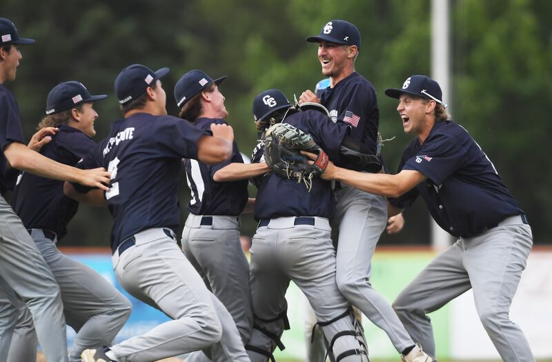 Cary-Grove starting pitcher Charlie Taczy, middle, celebrates with his teammates after going the distance during the Trojans’ win over St. Patrick during the Class 3A supersectional baseball game at Wintrust Field on Monday, June 9, 2025 in Schaumburg.