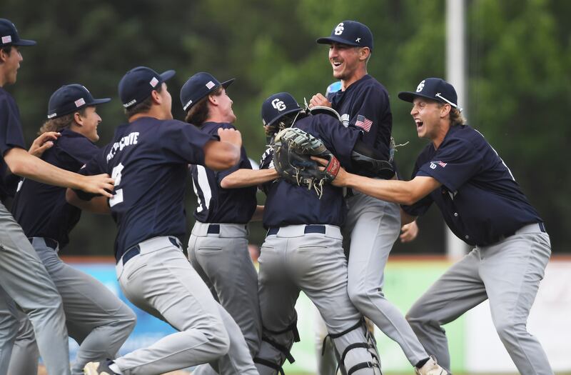 Cary-Grove starting pitcher Charlie Taczy, middle, celebrates with his teammates after going the distance during the Trojans’ win over St. Patrick during the Class 3A supersectional baseball game at Wintrust Field on Monday, June 9, 2025 in Schaumburg.